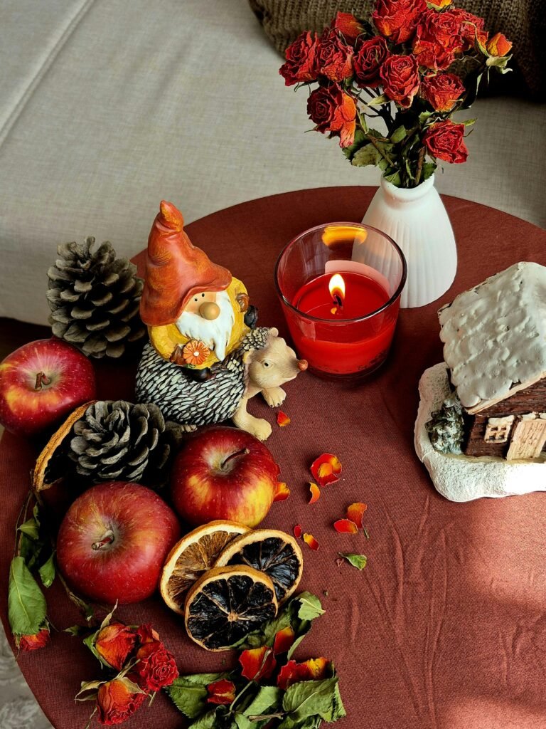 Warm autumn table setting with apples, candle, and rustic decor, perfect for cozy seasonal ambiance.